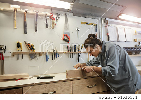 Repairman working with wood 61036531