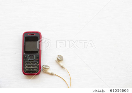 older mobile phone press the button old generation with earphone 61036606