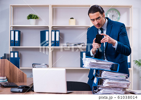 Young handsome businessman working in the office 61038014