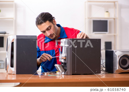 Young engineer repairing musical hi-fi system Young engineer repairing musical hi-fi system 61038740