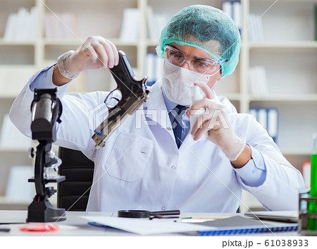 The forensics investigator working in lab on crime evidence The forensics investigator working in lab on crime evidence 61038933