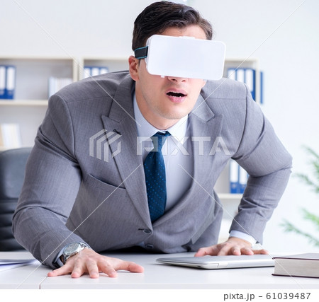 Businessman with virtual reality glasses in modern technology co 61039487