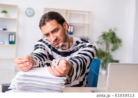 Young employee feeling like prisoner at work Young employee feeling like prisoner at work 61039513