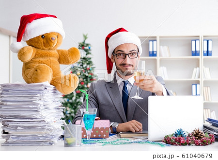 Young businessman celebrating christmas in the office 61040679