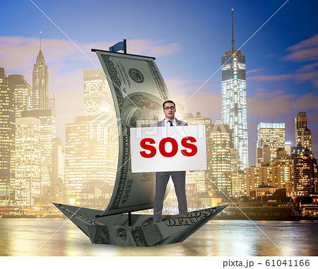 Businessman asking for help with SOS message on boat 61041166