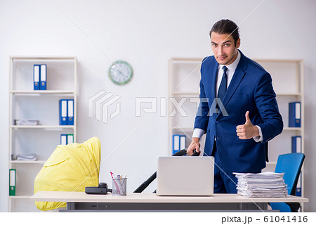 Young father looking after newborn in the office Young father looking after newborn in the office 61041416