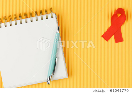 red aids ribbon on open notebook isolated red aids ribbon on open notebook isolated 61041770