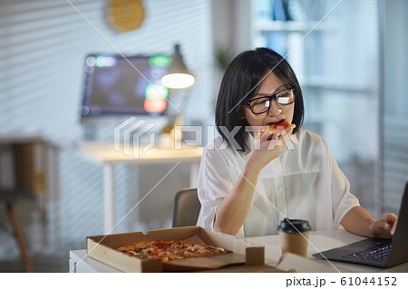 Woman has a lunch at office Woman has a lunch at office 61044152