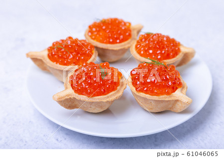 Red caviar (salmon caviar) in tartlets. Selective focus, close-up. Red caviar (salmon caviar) in tartlets. Selective focus, close-up. 61046065