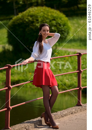 Portrait of a girl in red skirt and white blouse Portrait of a girl in red skirt and white blouse 61046229