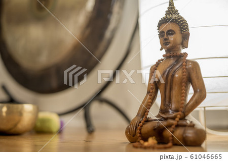 Wooden Buddha statue in a veditation room. 61046665