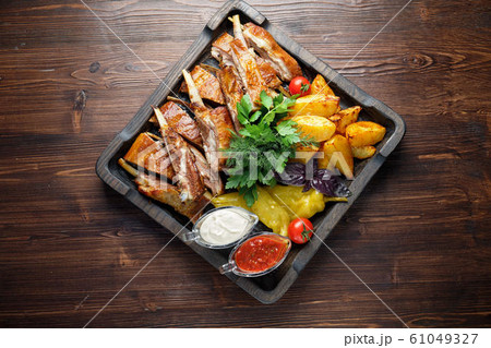 Barbecue on the bones with vegetables and potatoes . catering menu 61049327