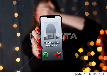 Phone call from unknown number. Scam, fraud or phishing with smartphone concept. Prank caller, scammer or stranger. Woman answering to incoming call. Hoax person with fake identity Phone call from unknown number. Scam, fraud or phishing with smartphone concept. Prank caller, scammer or stranger. Woman answering to incoming call. Hoax person with fake identity 61050461
