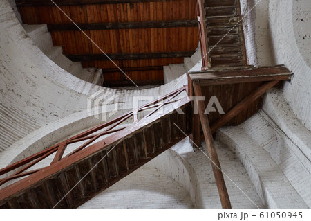 Old decrepit wooden staircase leading up inside of the building Old decrepit wooden staircase leading up inside of the building 61050945