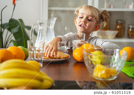 Cute little girl reaching out for cookie Cute little girl reaching out for cookie 61051319