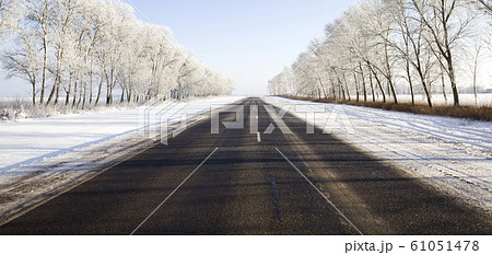 wide paved winter road wide paved winter road 61051478