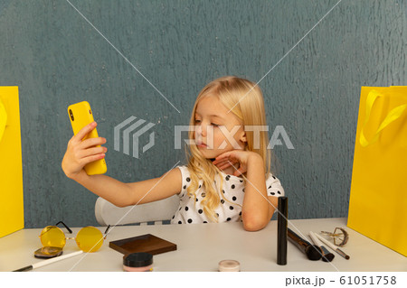 Happy girl at home speaking in front of camera for vlog. Young black woman working as blogger, recording video tutorial for Internet. Happy girl at home speaking in front of camera for vlog. Young black woman working as blogger, recording video tutorial for Internet. 61051758