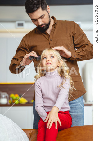 Loving father brushing hair of his daughter Loving father brushing hair of his daughter 61052025