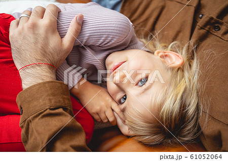 Adorable little girl cuddling with dad at home Adorable little girl cuddling with dad at home 61052064