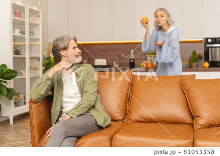 Upset mature male listening to his wife Upset mature male listening to his wife 61053358