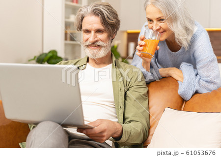 Smiling Caucasian male looking at his computer Smiling Caucasian male looking at his computer 61053676