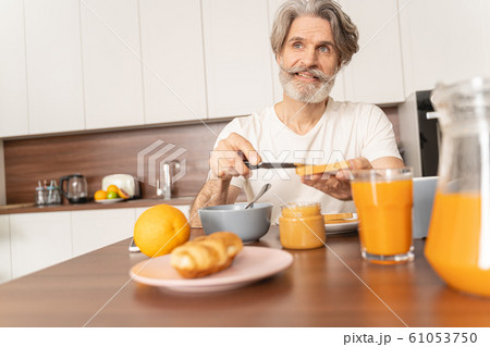 Man spreading peanut butter with a knife Man spreading peanut butter with a knife 61053750
