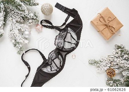Black lace lingerie and perfume bottle. Top view. Gift set of women's accessories and underwear 61062626