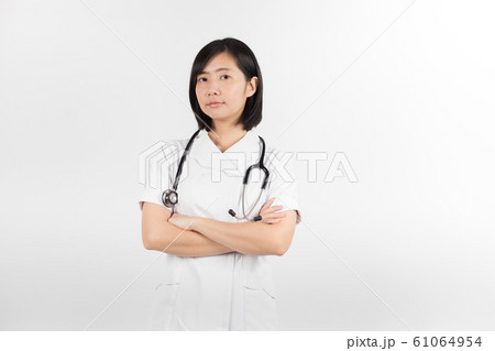 Young asian nurse with a stethoscope isolated over white background. Young asian nurse with a stethoscope isolated over white background. 61064954
