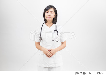 Young asian nurse with a stethoscope isolated over white background. Young asian nurse with a stethoscope isolated over white background. 61064972