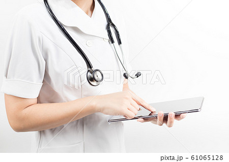 Young asian nurse with a stethoscope using a digital tablet, isolated over white background. Young asian nurse with a stethoscope using a digital tablet, isolated over white background. 61065128