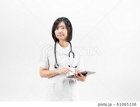 Young asian nurse with a stethoscope using a digital tablet, isolated over white background. Young asian nurse with a stethoscope using a digital tablet, isolated over white background. 61065136