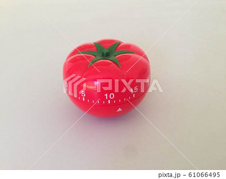 Pomodoro Timer red with green details. Tomato on the table. Vibrant, multi-angle colors. 61066495