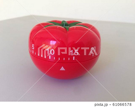 Pomodoro Timer red with green details. Tomato on the table. Vibrant, multi-angle colors. 61066578
