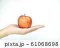 Close up red apple in hand on white isolated background 61068698