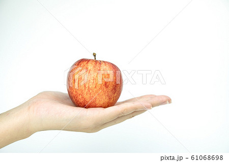 Close up red apple in hand on white isolated background 61068698