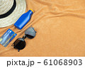 Top view of beach background. eyeglasses and credit card and sunscreen lotion and woven hats 61068903