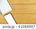 Smart phone and empty notepad and pencil on desk, mock up on screen, copy space	 61068907