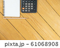 Empty notepad and calculator and pencil on wooden desk, copy space, top view background 61068908