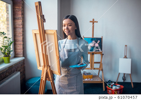 Joyful long haired woman enjoying her occupation Joyful long haired woman enjoying her occupation 61070457