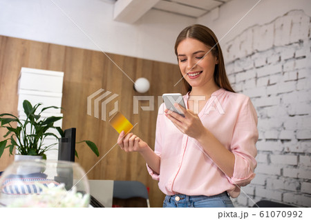 Receptionist providing payment details to a client 61070992