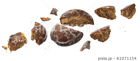 Falling broken gingerbread isolated on white background Falling broken gingerbread isolated on white background 61071154