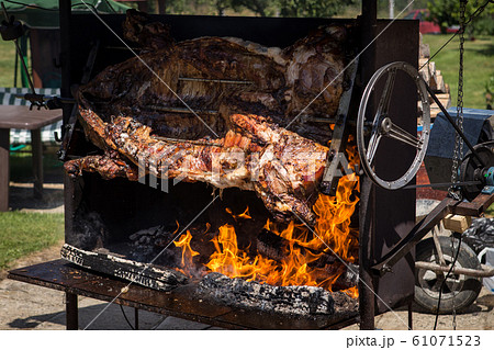 Piglet roasted on a spit Piglet roasted on a spit 61071523