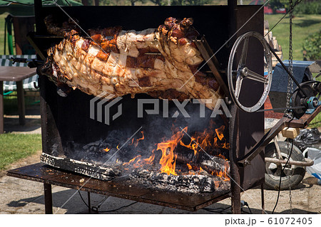 Piglet roasted on a spit Piglet roasted on a spit 61072405