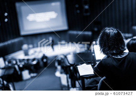 Audience in the lecture hall attending business conference event. 61073427