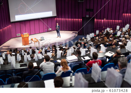 Speaker giving presentation on business conference event. 61073428