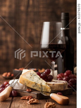 Glass and bottle of red wine with selection of 61074070