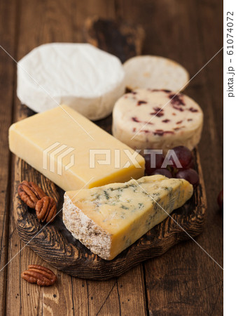 Selection of various cheese on the board on wooden Selection of various cheese on the board on wooden 61074072