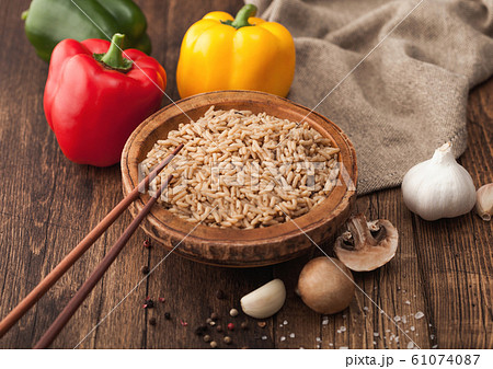 Wooden bowl with boiled long grain risotto rice 61074087