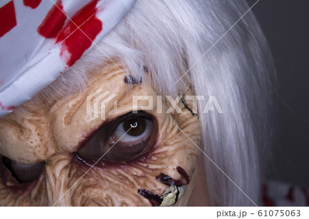 Woman dressed as a killer nurse for Halloween Woman dressed as a killer nurse for Halloween 61075063