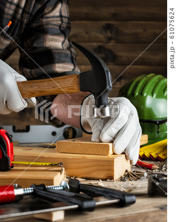 Carpenter at work on wooden boards. Carpentry. Carpenter at work on wooden boards. Carpentry. 61075624